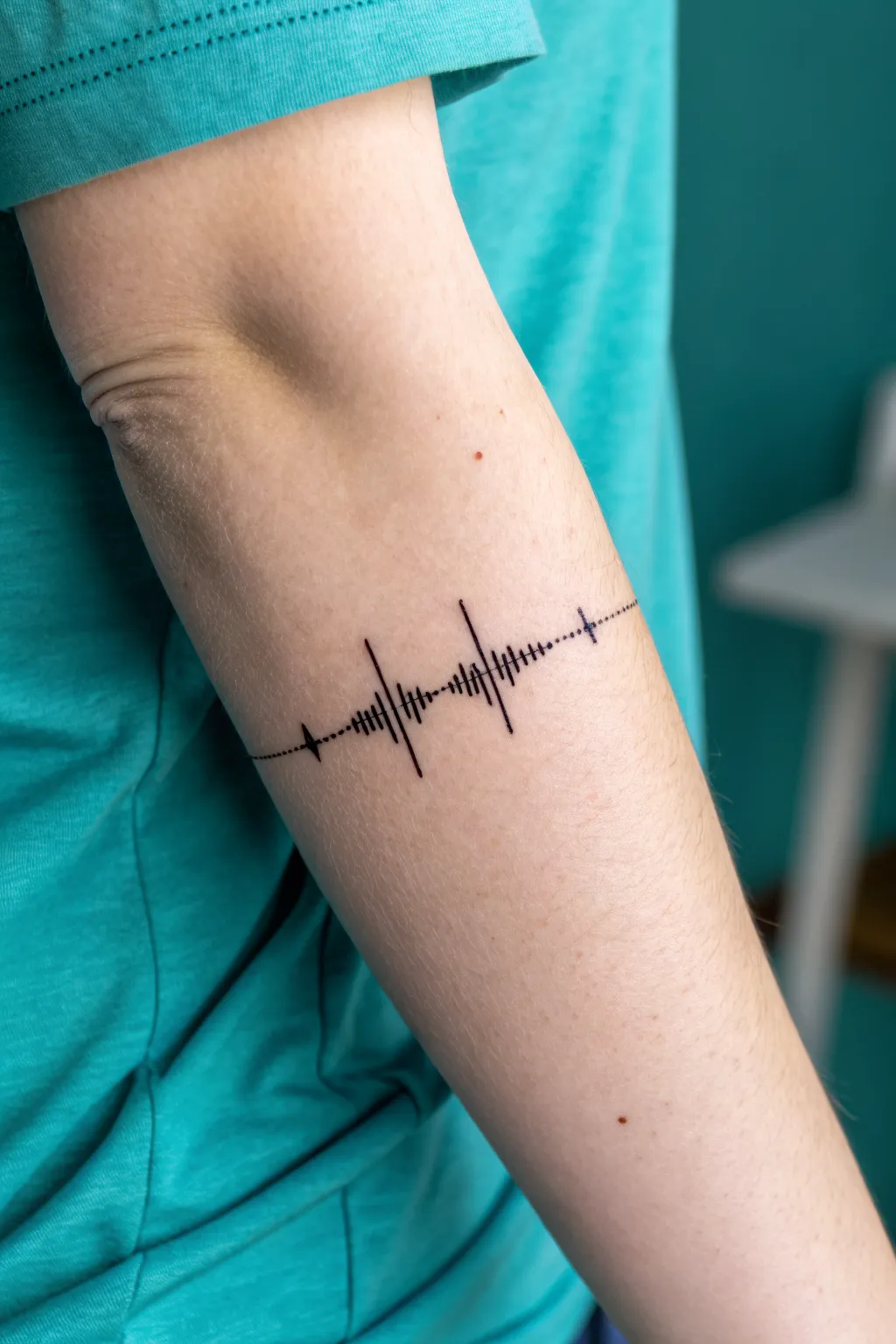 Minimal soundwave love tattoo detail with micro accents, Scandinavian-boho studio vibe.
