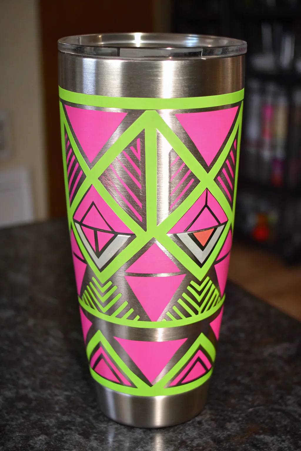 Paint a neon glow tumbler with halo highlights and glossy sealer shine in moody light.