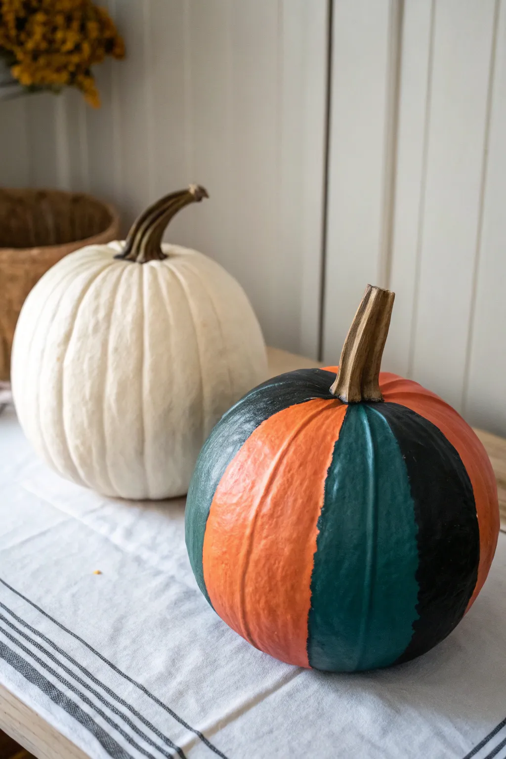 One pumpkin, two stages: drying paper mache warts on one side, bold painted finish on the other.