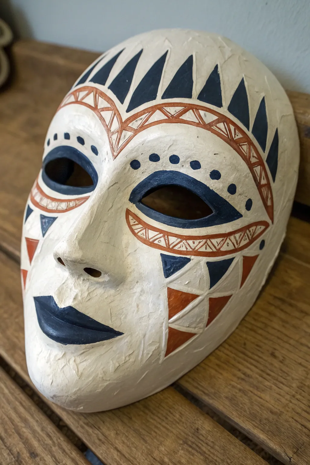 White mask with peeling-paint illusion revealing bold underlayer, minimalist Scandinavian boho vibe