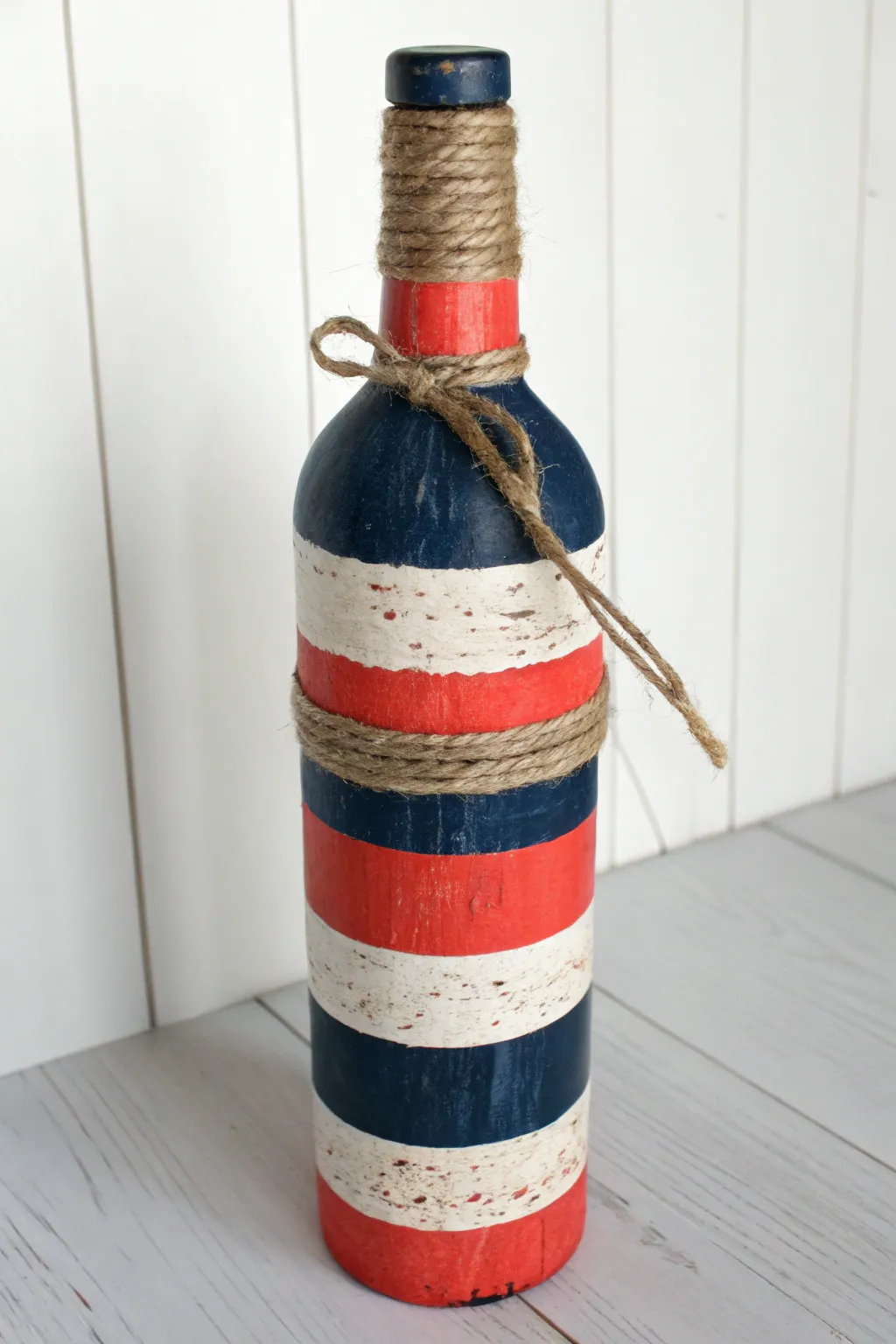Bold buoy stripes and rope-wrapped neck turn a bottle into chic minimalist coastal decor.