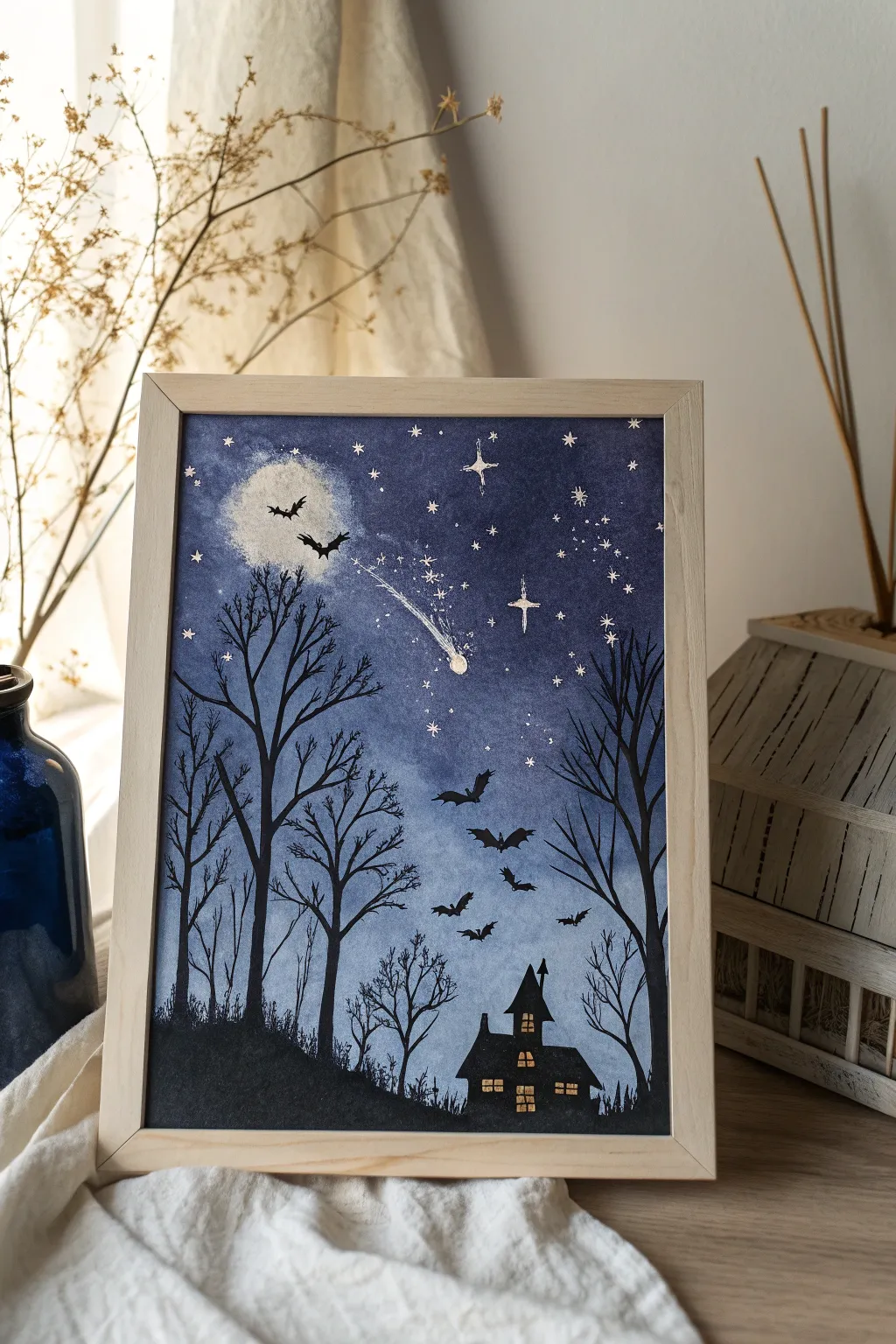 Indigo splatter night sky with haunted house silhouettes for chic minimalist Halloween acrylic art