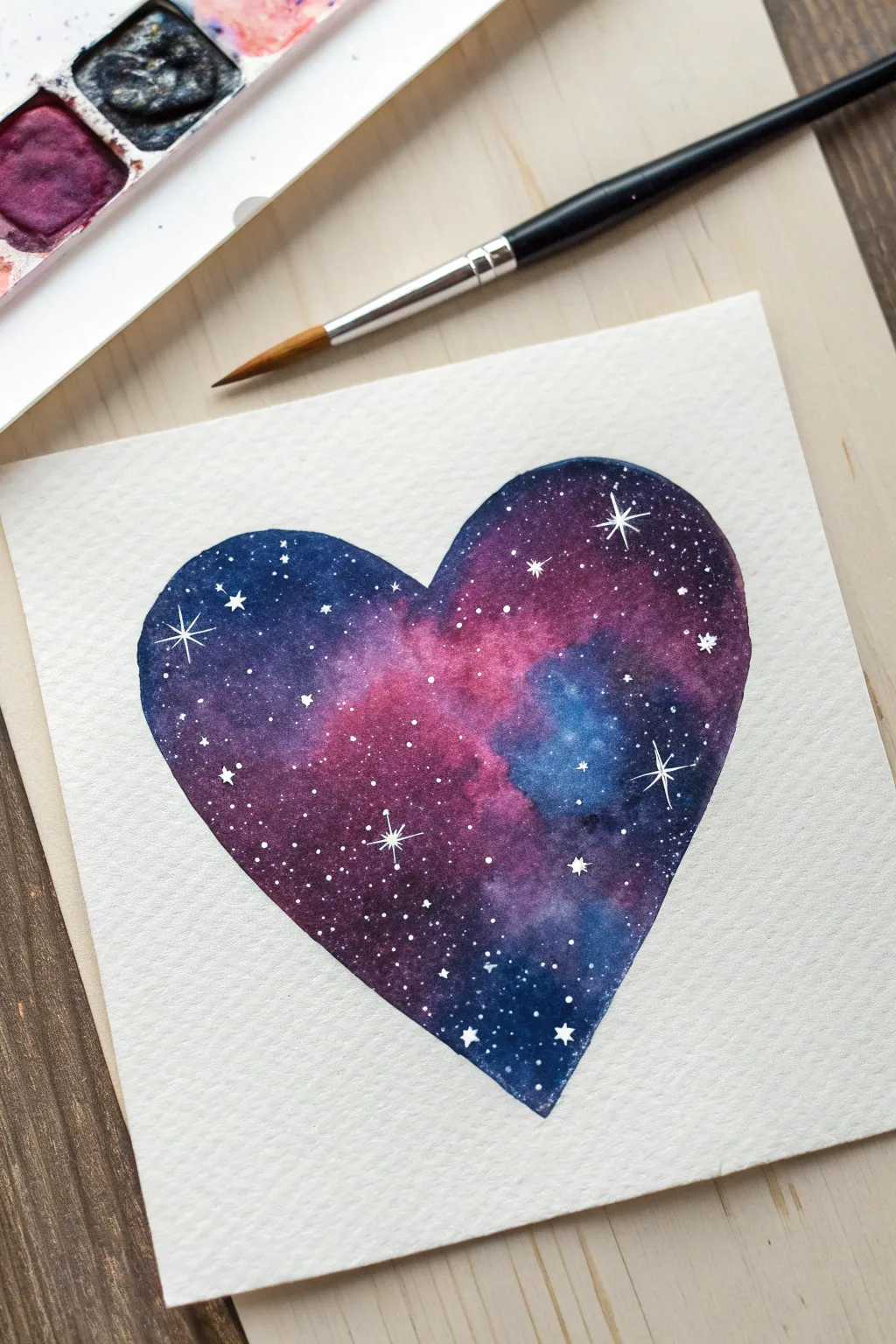 Paint a dreamy galaxy heart with tiny stars and a glowing nebula, minimalist and boho.