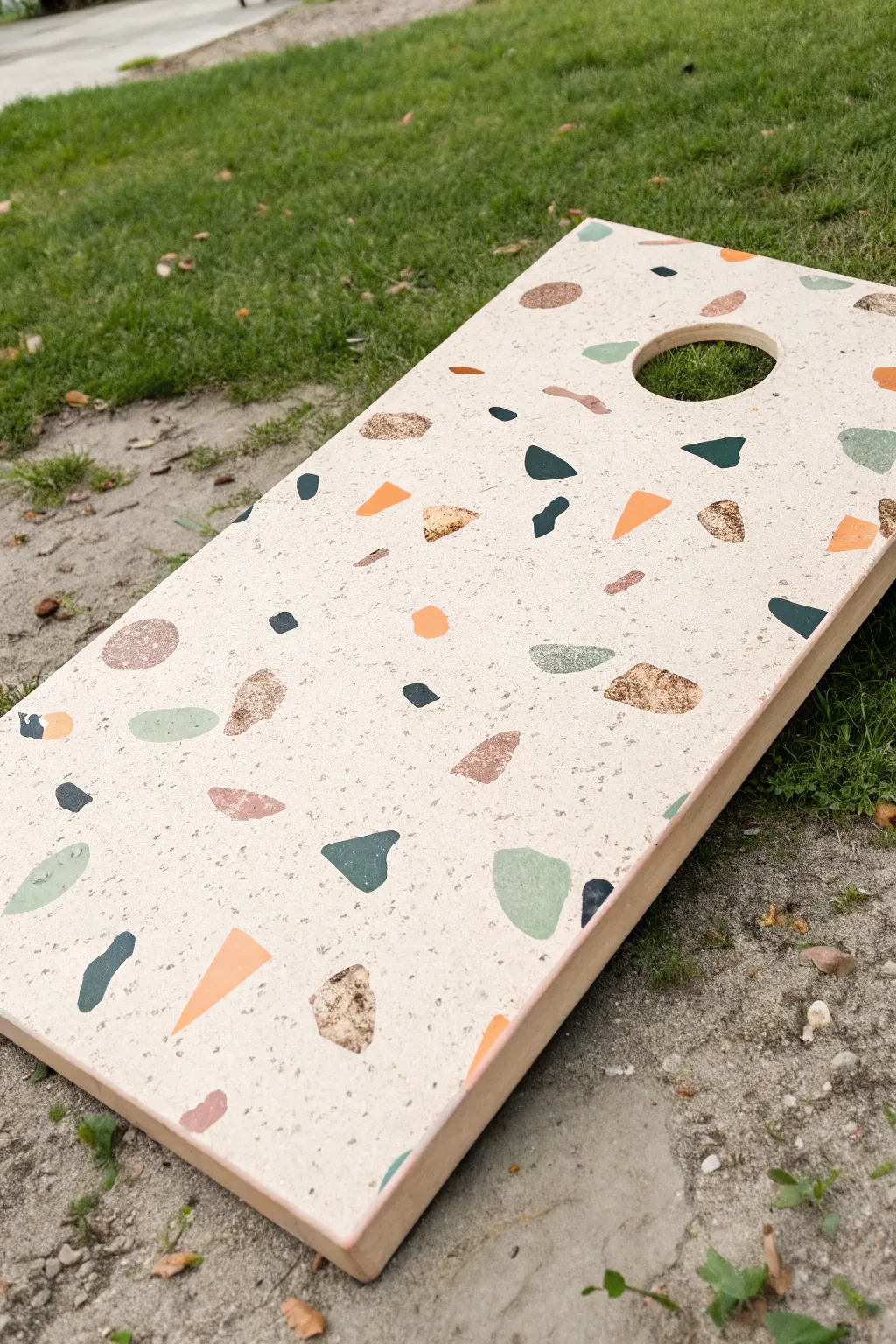Terrazzo chips on a neutral cornhole board for a playful, classy minimalist look