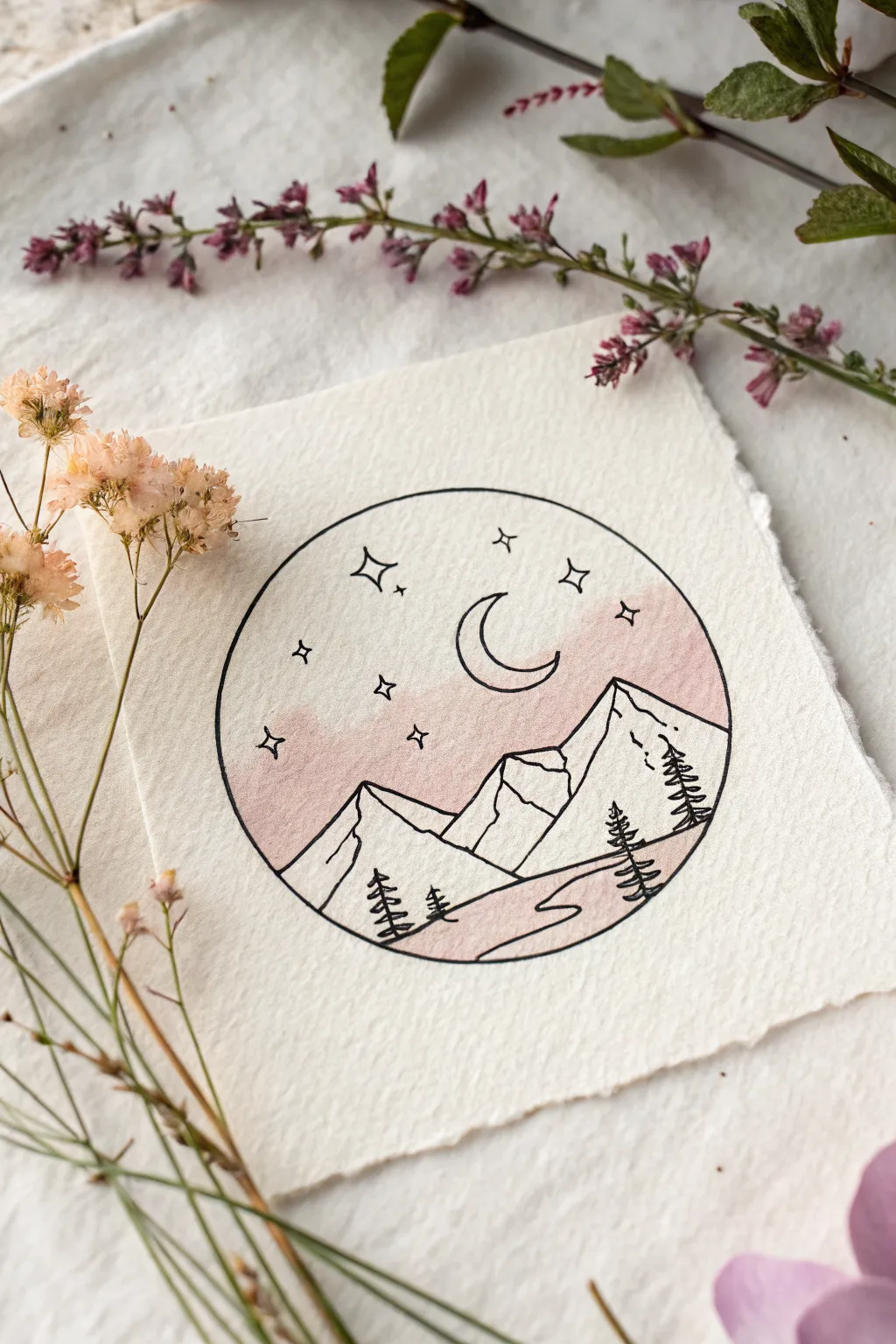 Simple circle landscape vignette: mountains, moon, and stars in soft pastel watercolor wash.