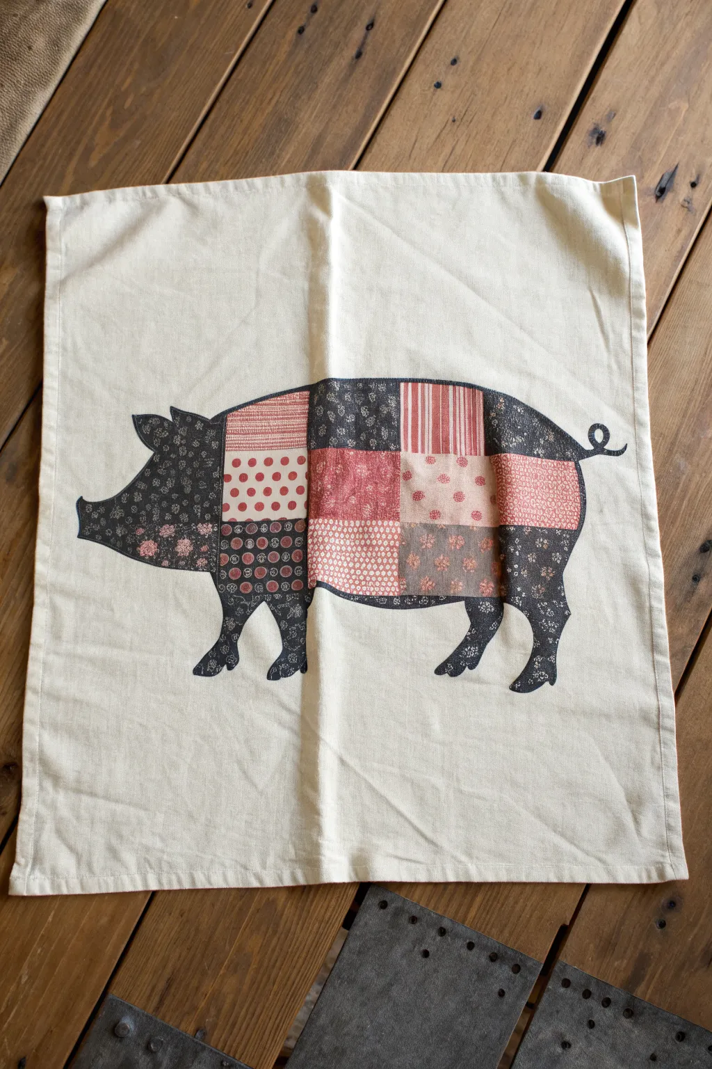 Patchwork pig silhouette in pinks and reds, with a bold outline and easy, playful patterns.