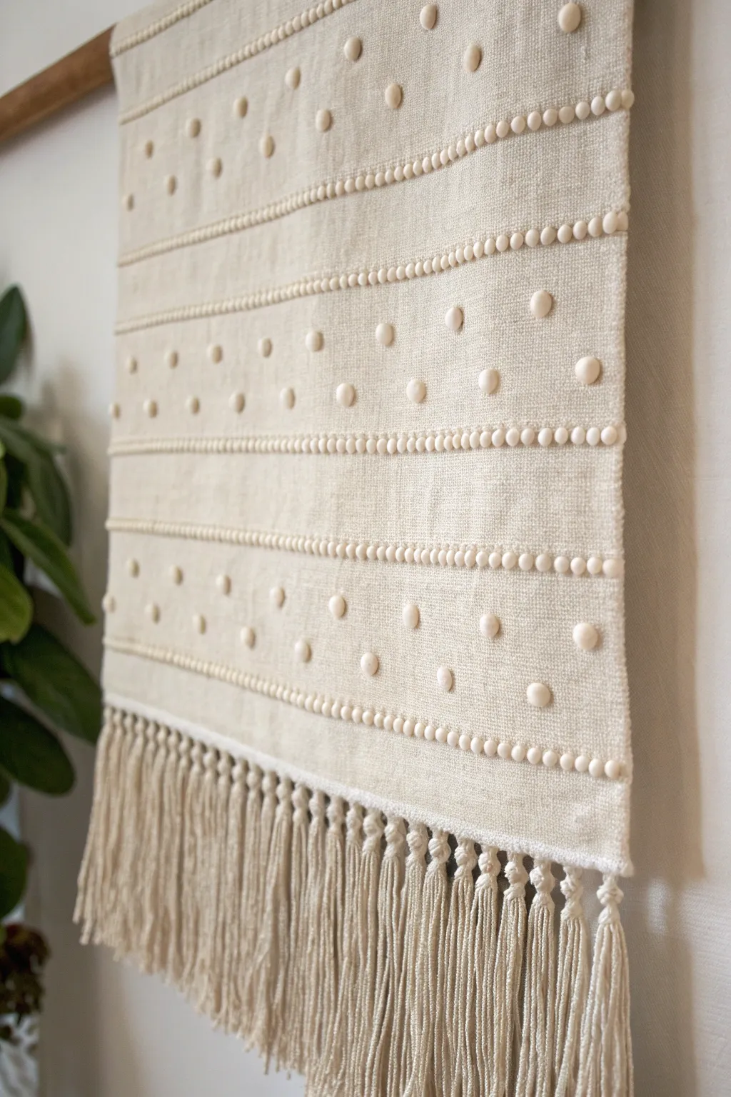 DIY idea: puffy paint beaded fringe adds soft 3D texture to a minimalist wall hanging.