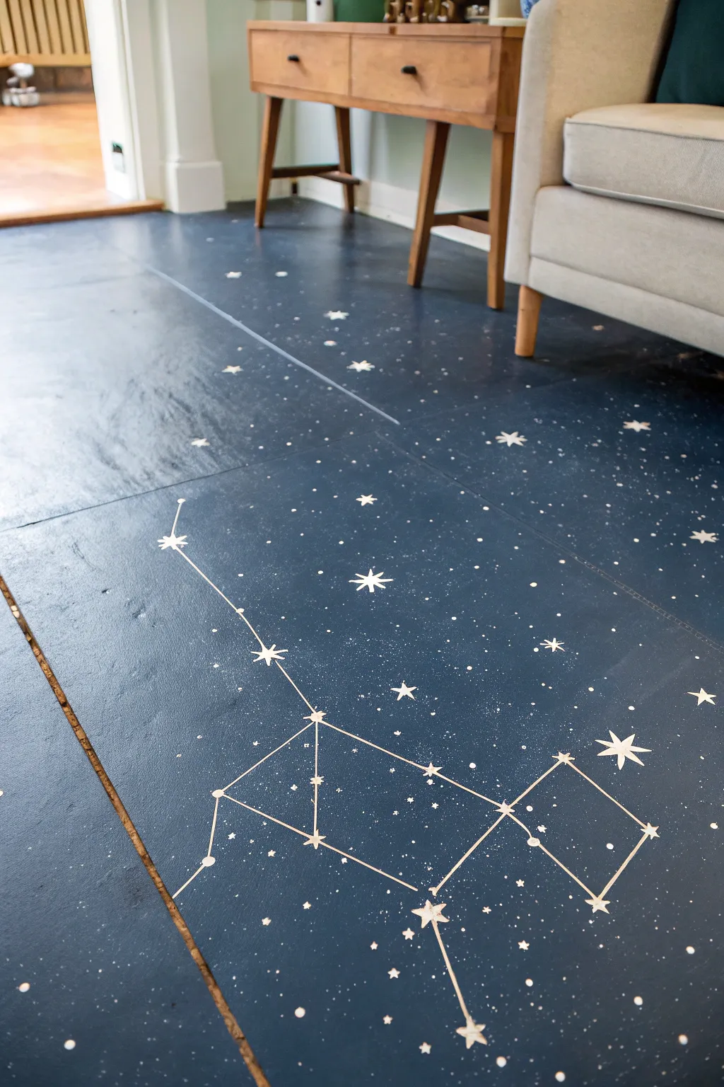 Night-sky concrete floor with crisp constellations and tiny splatter stars in cozy minimalist style