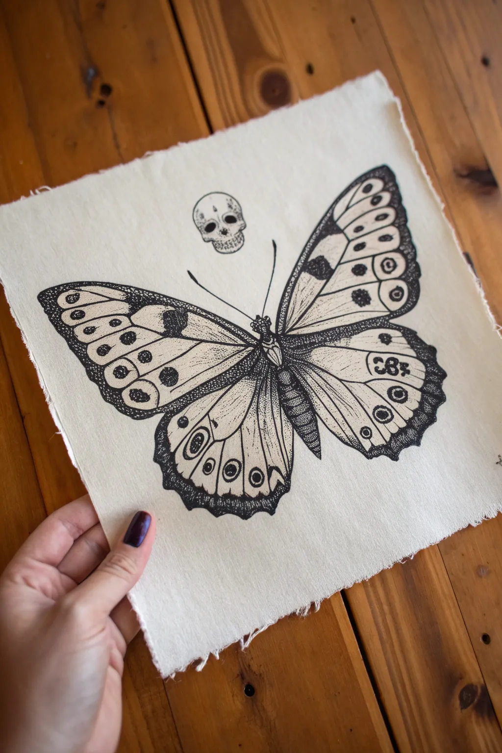 Minimal ink butterfly with hidden skull motifs, a chic goth sketch for your surreal sketchbook