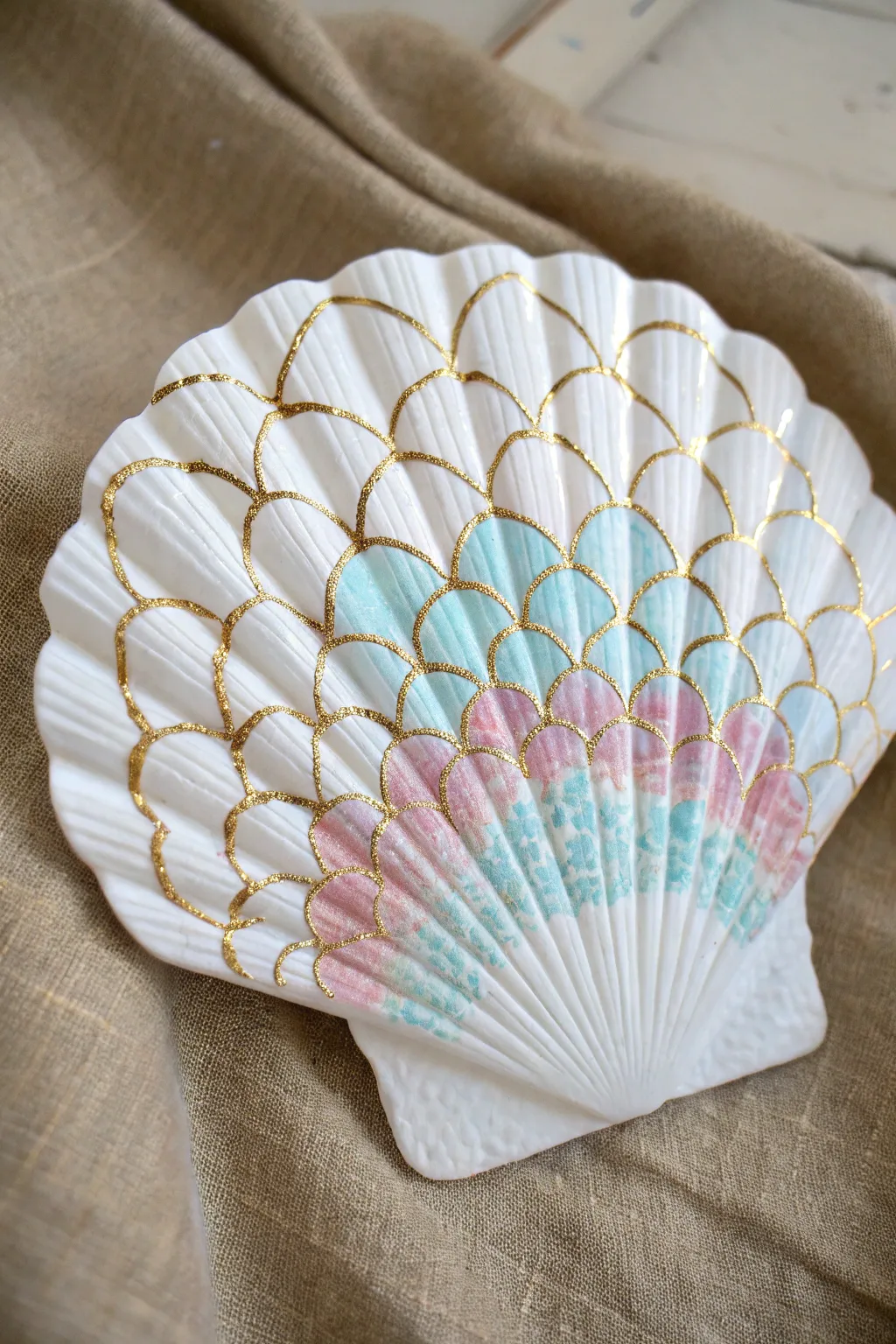 Bring a touch of ocean magic home with this shimmering mermaid scale painted shell art idea.
