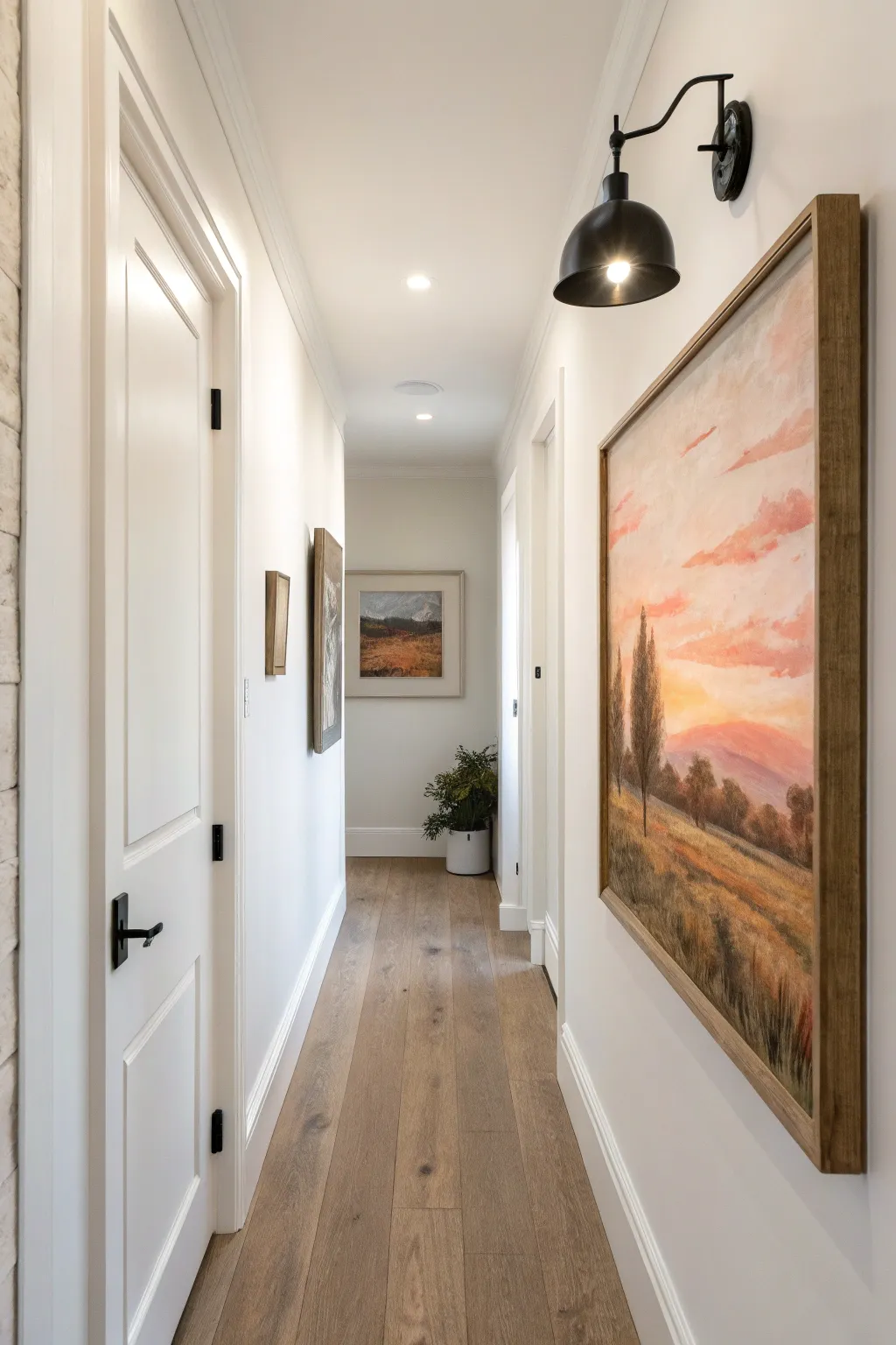 Painted halo highlights and a simple sconce turn your hallway mural into a mini gallery moment.