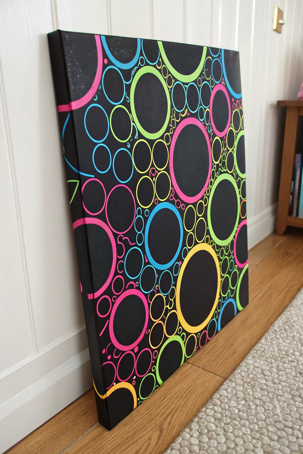 Matte black circles meet glossy neon pour for a bold negative-space statement on black canvas.