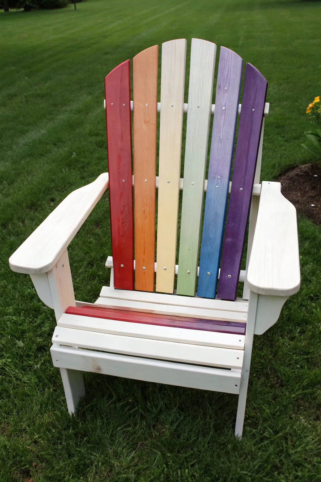 Rainbow slats on a neutral-frame Adirondack chair for a playful, minimalist outdoor pop.