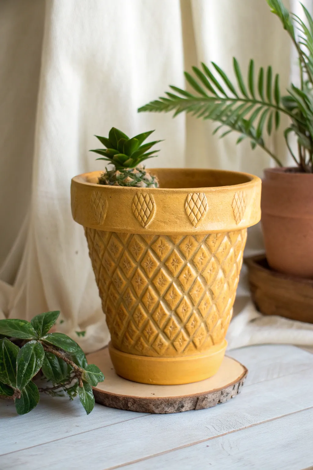 Golden pineapple terracotta pot with textured crisscross and leafy crown in soft boho minimal style