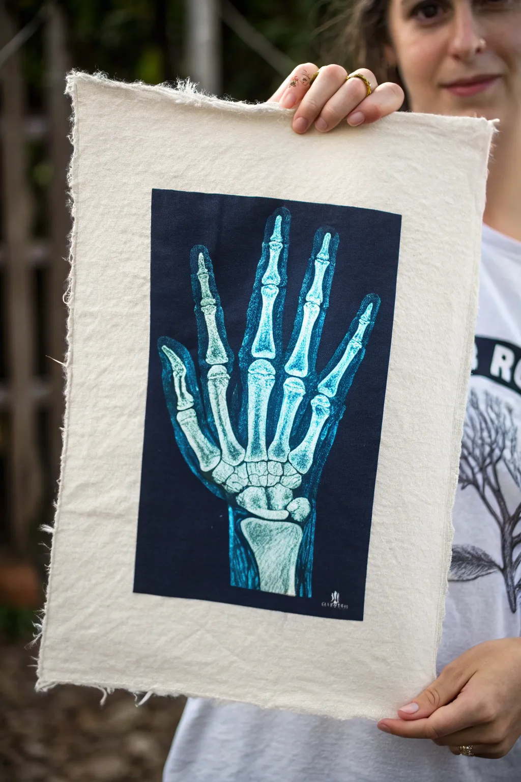 Cool blue X-ray hand study with glowing highlights, minimalist film-plate mood aesthetic