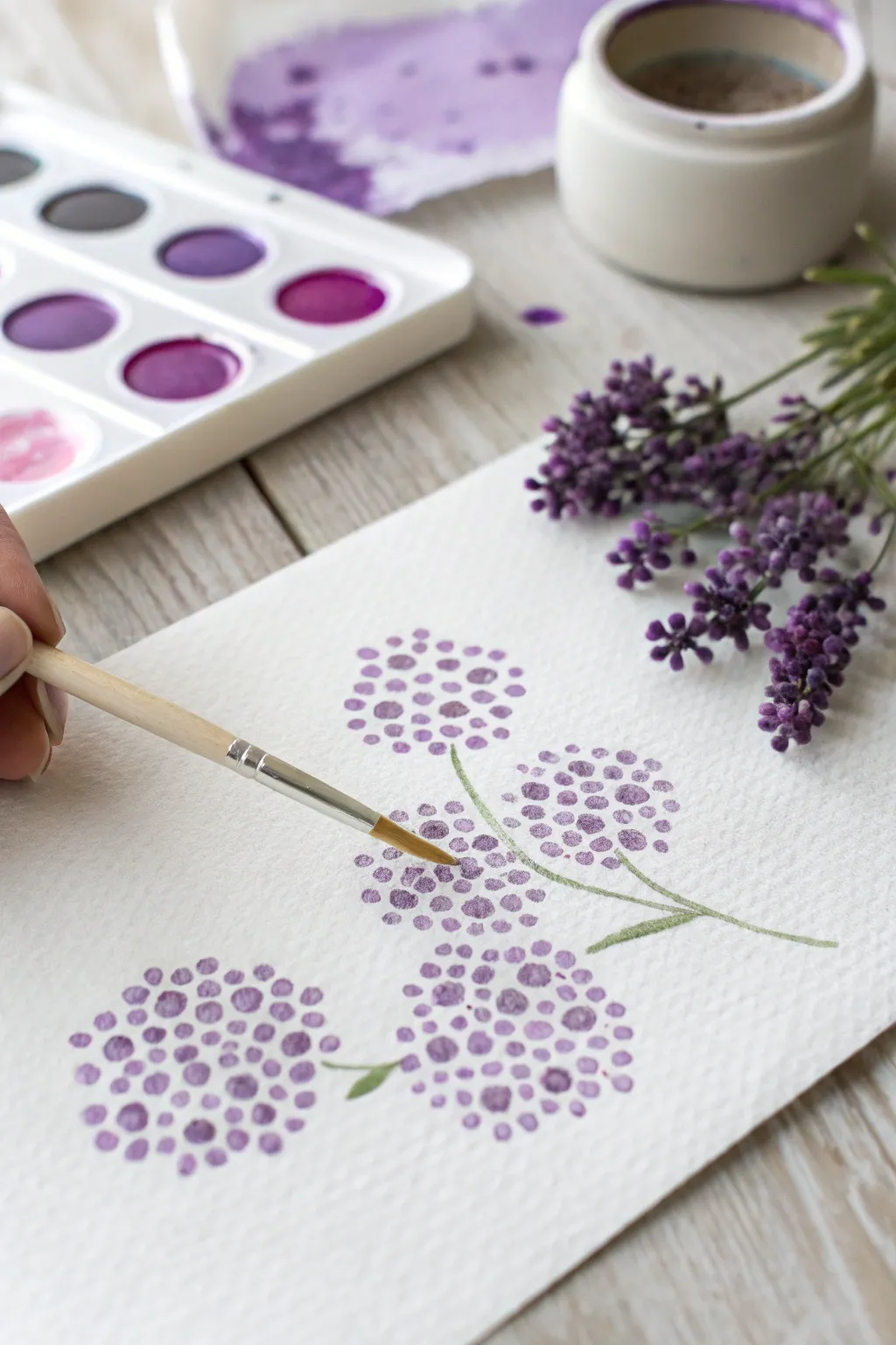 Cotton swab dot clusters turn two purple paints into easy lilac and lavender texture.