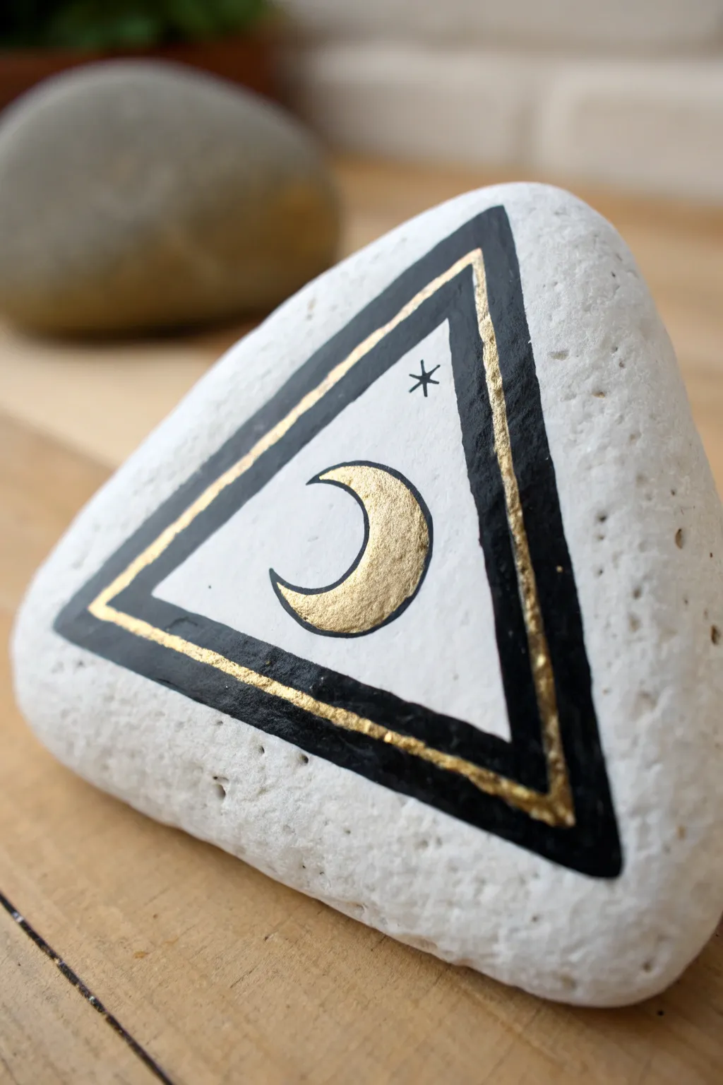 Triangle rock with bold edge framing and clean negative space, finished with a tiny boho icon.