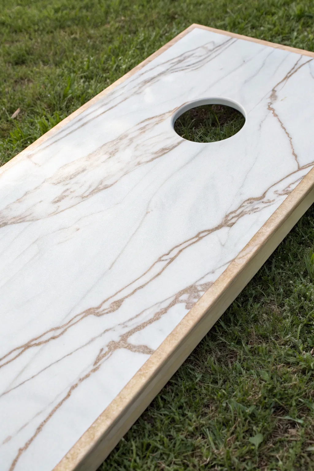 Faux marble veining swirling toward the hole, finished with a soft glossy seal and clean contrast.