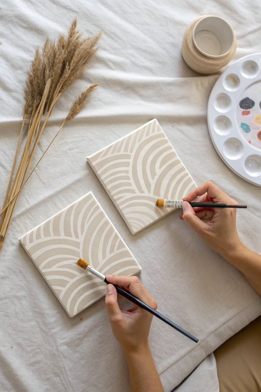 Mirror-painting date night: two canvases, same strokes reversed, hands in sync on linen.