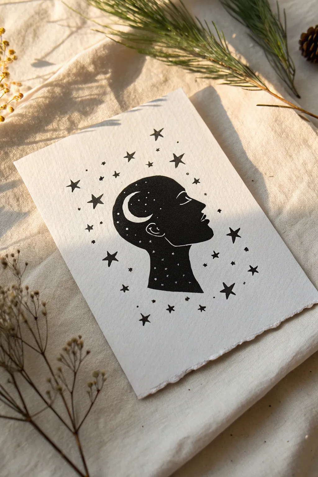 Easy head silhouette drawing filled with stars and moon, minimalist black ink on warm paper
