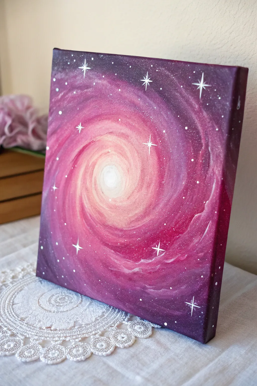 Pink galaxy canvas with splatter stars and radiant center glow for easy DIY painting inspiration