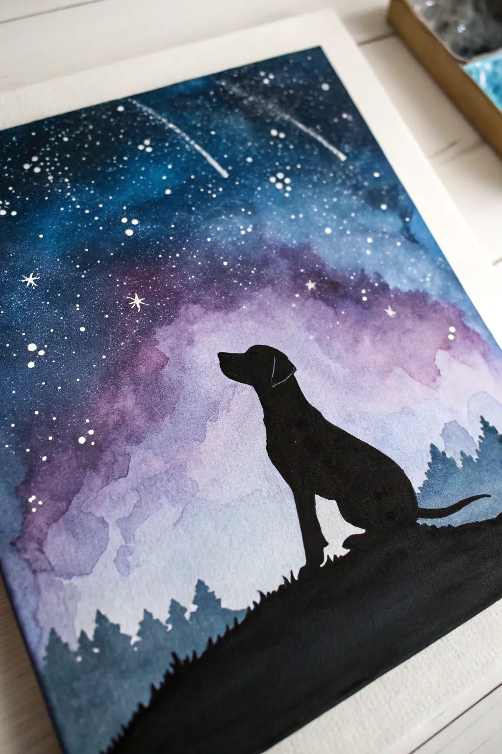 Dreamy galaxy sky behind a crisp dog silhouette, an easy painting idea with bold contrast