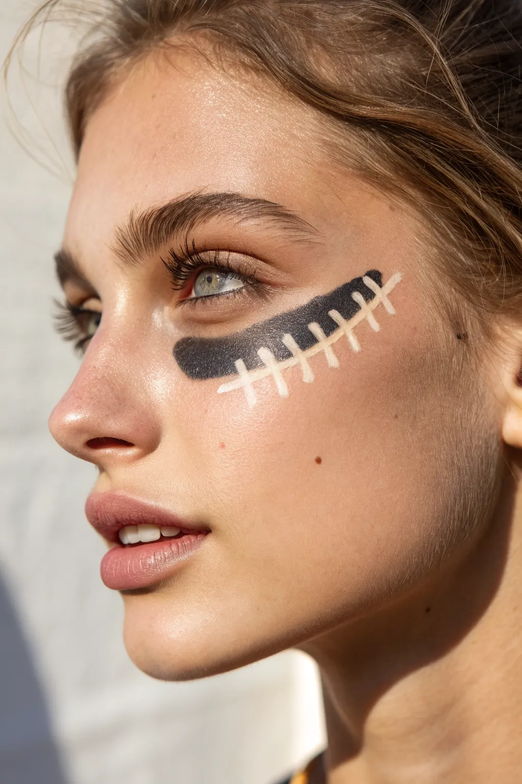 Dark eye-black base with a crisp neon outline for bold, game-day face paint contrast