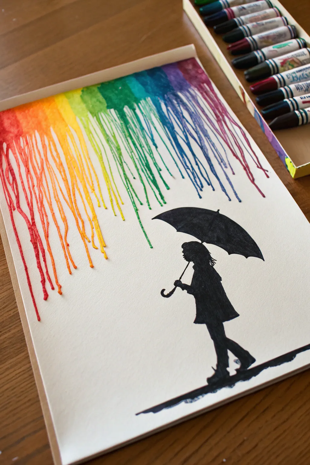 Try this melted crayon rain backdrop with a bold umbrella silhouette for instant contrast