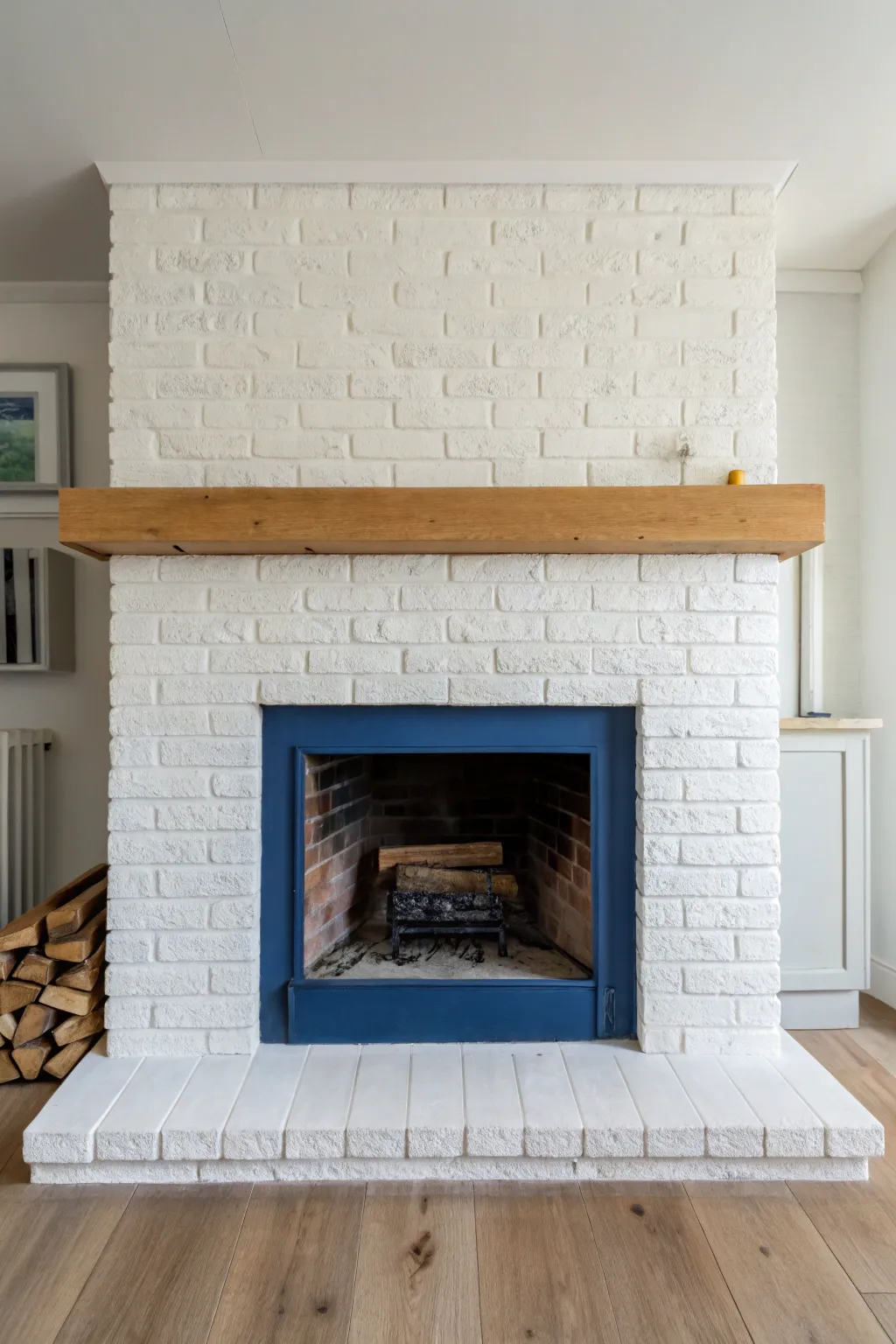 Neutral painted brick fireplace with bold blue firebox back panel for an unexpected pop.