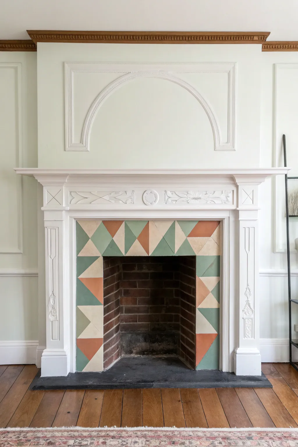 Geometric color-block mantel face in muted boho tones for a clean Scandinavian focal point