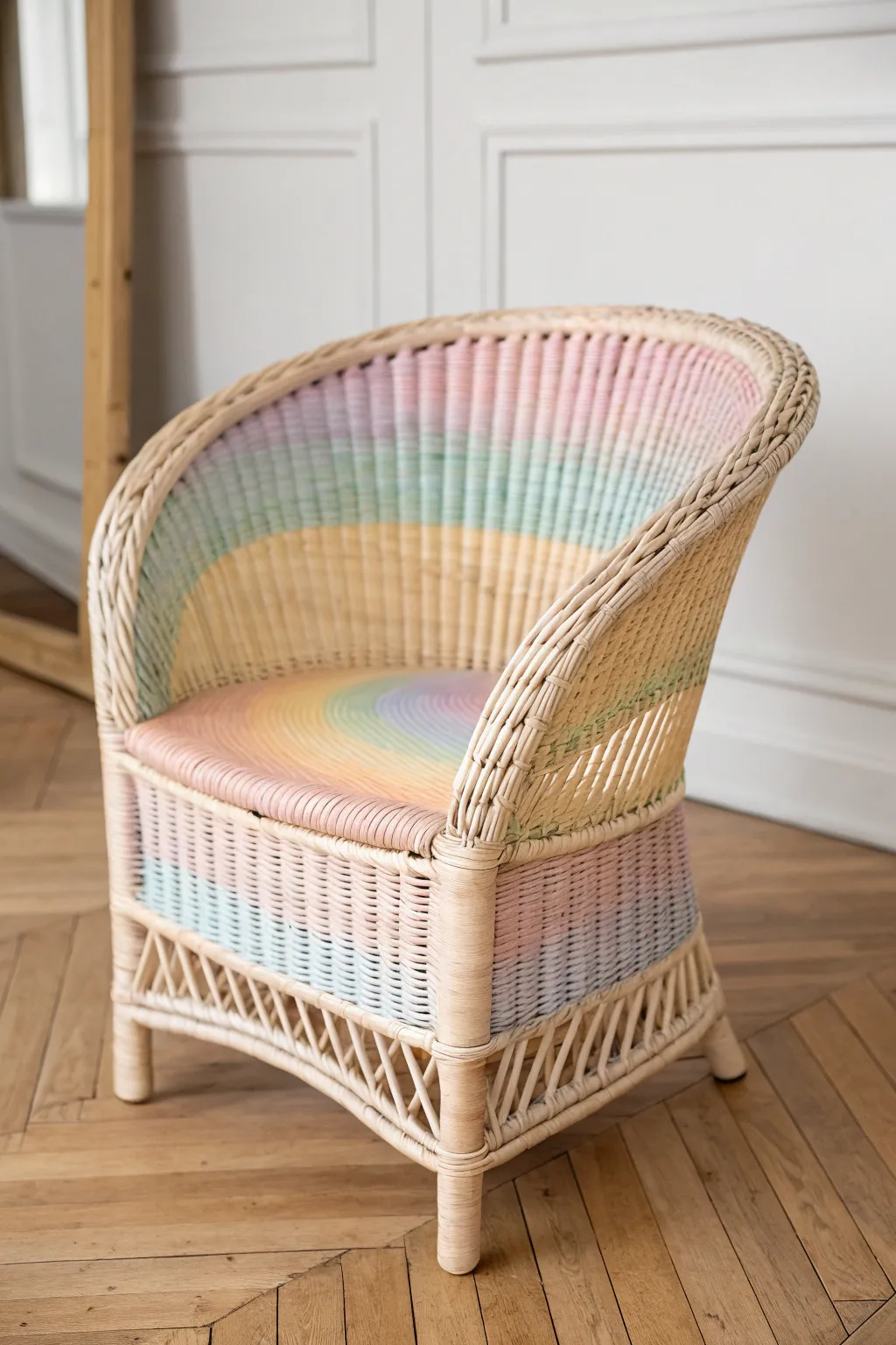Soft rainbow-painted wicker chair, minimalist styling for playful Scandinavian boho decor inspiration.