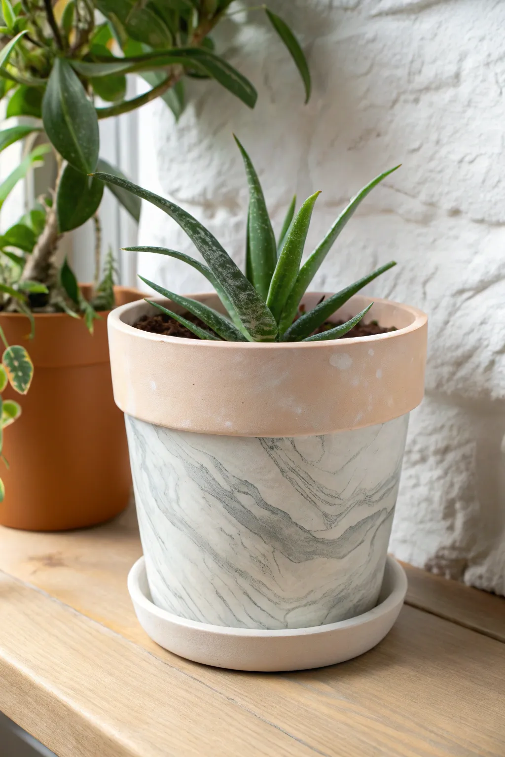 Minimal faux marble pot with soft gray veining, bright natural light, clean Scandinavian calm