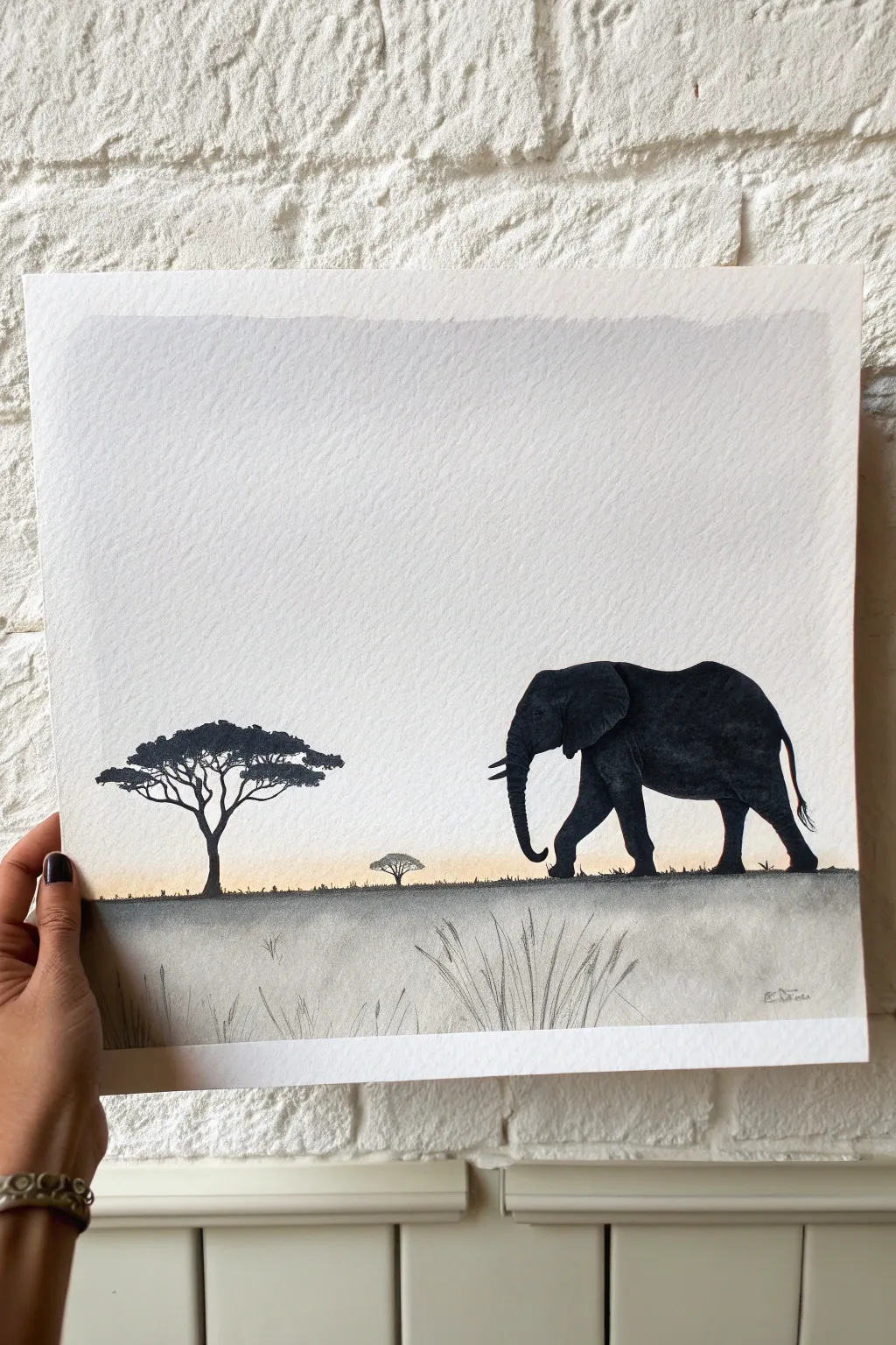 Minimalist safari: a bold elephant silhouette with airy negative space and a tiny acacia