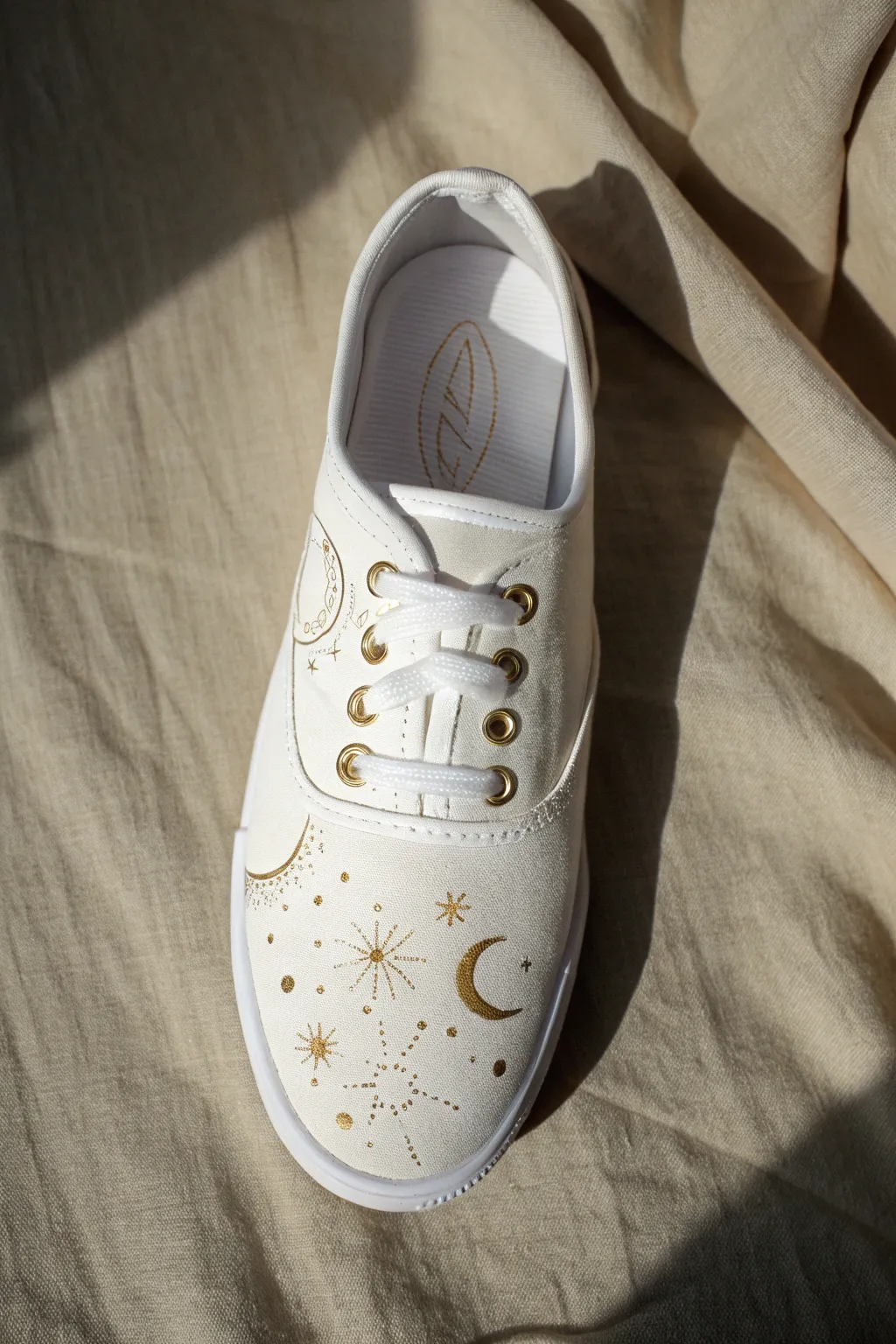 Moon phase and constellation sneaker art, split daylight and dim light to reveal a soft glow