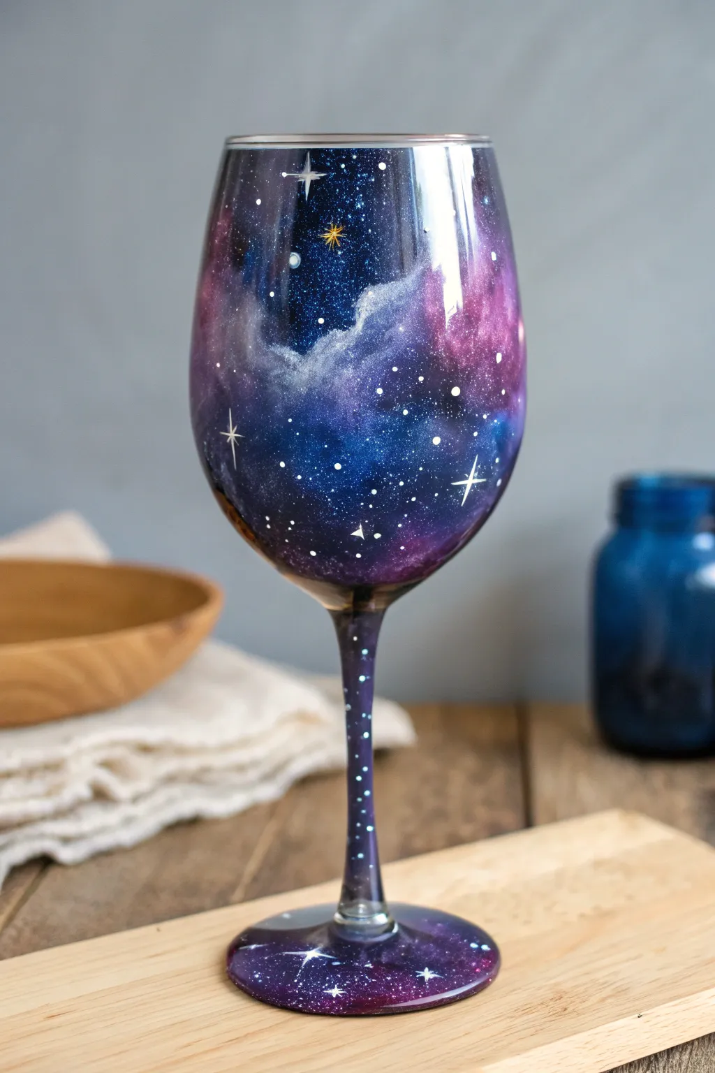 Hand-painted galaxy wine glass with deep blues, nebula clouds, and crisp starry contrast