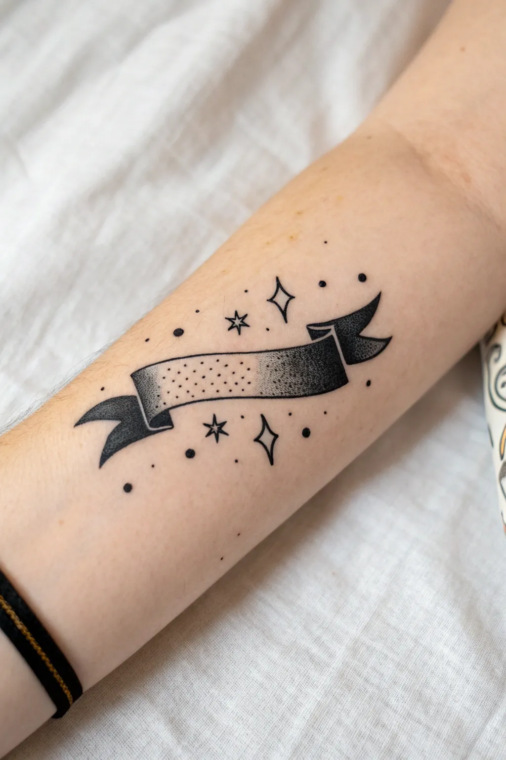 Easy arm paint idea: minimalist ribbon banner with star, dot, and swirl fillers for a boho look