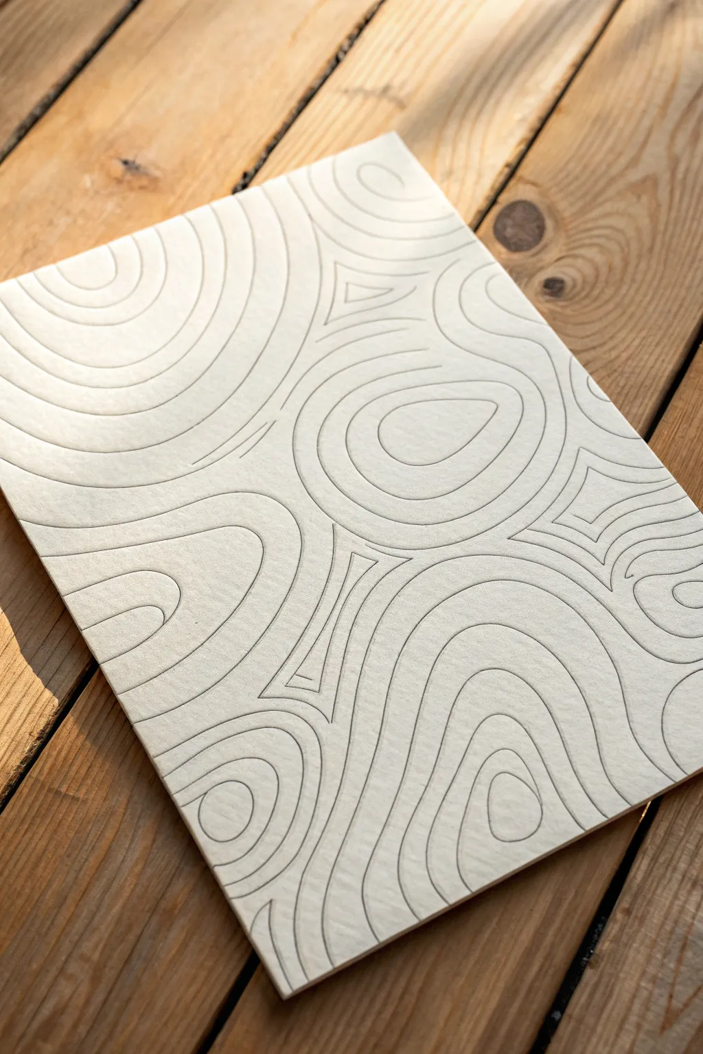 Muted topographic contour repeats on textured paper, a calm minimalist backdrop pattern idea.