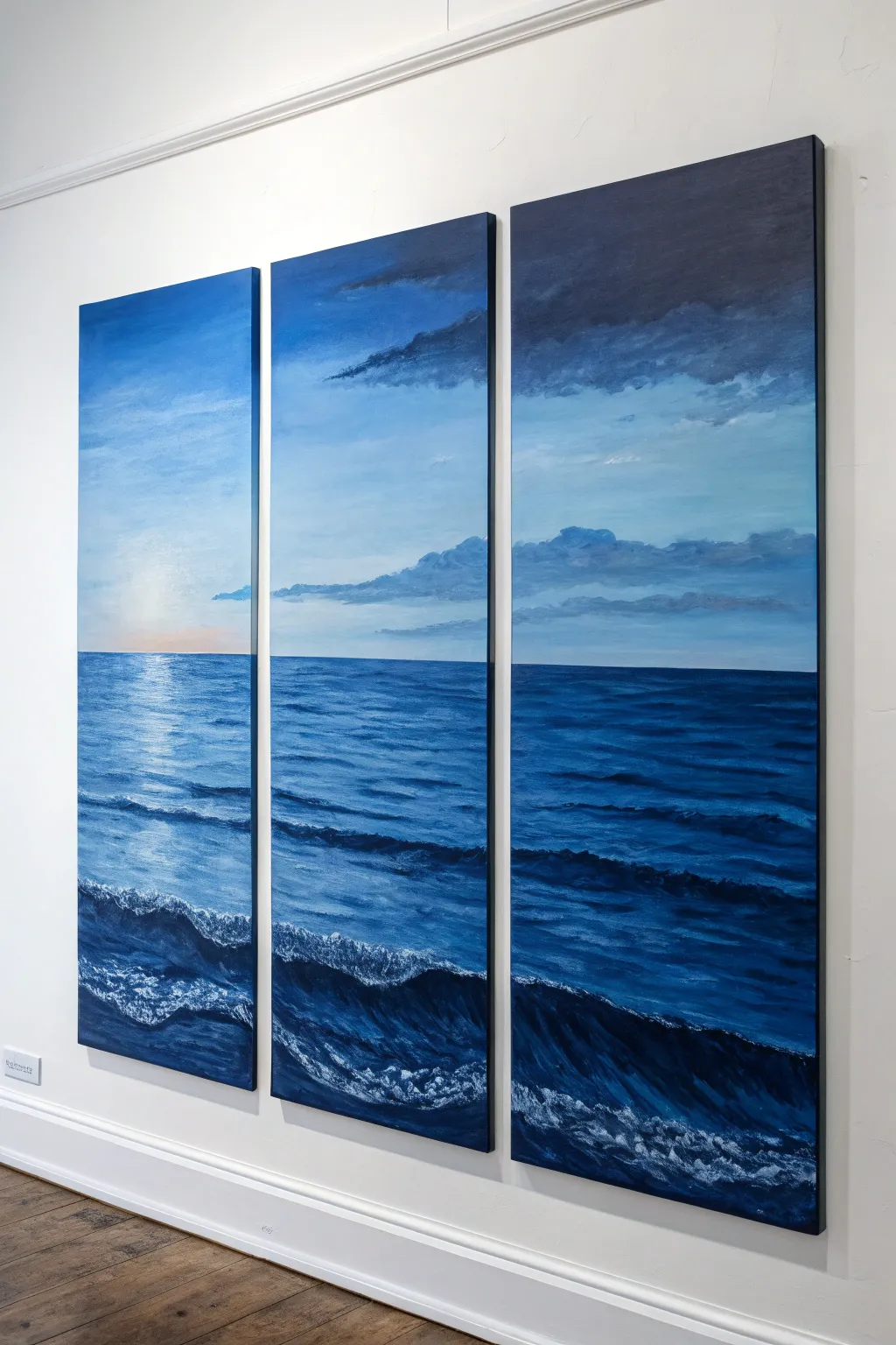 Blue tonal triptych from dawn to midnight, clean horizons, Scandinavian minimal with boho warmth.