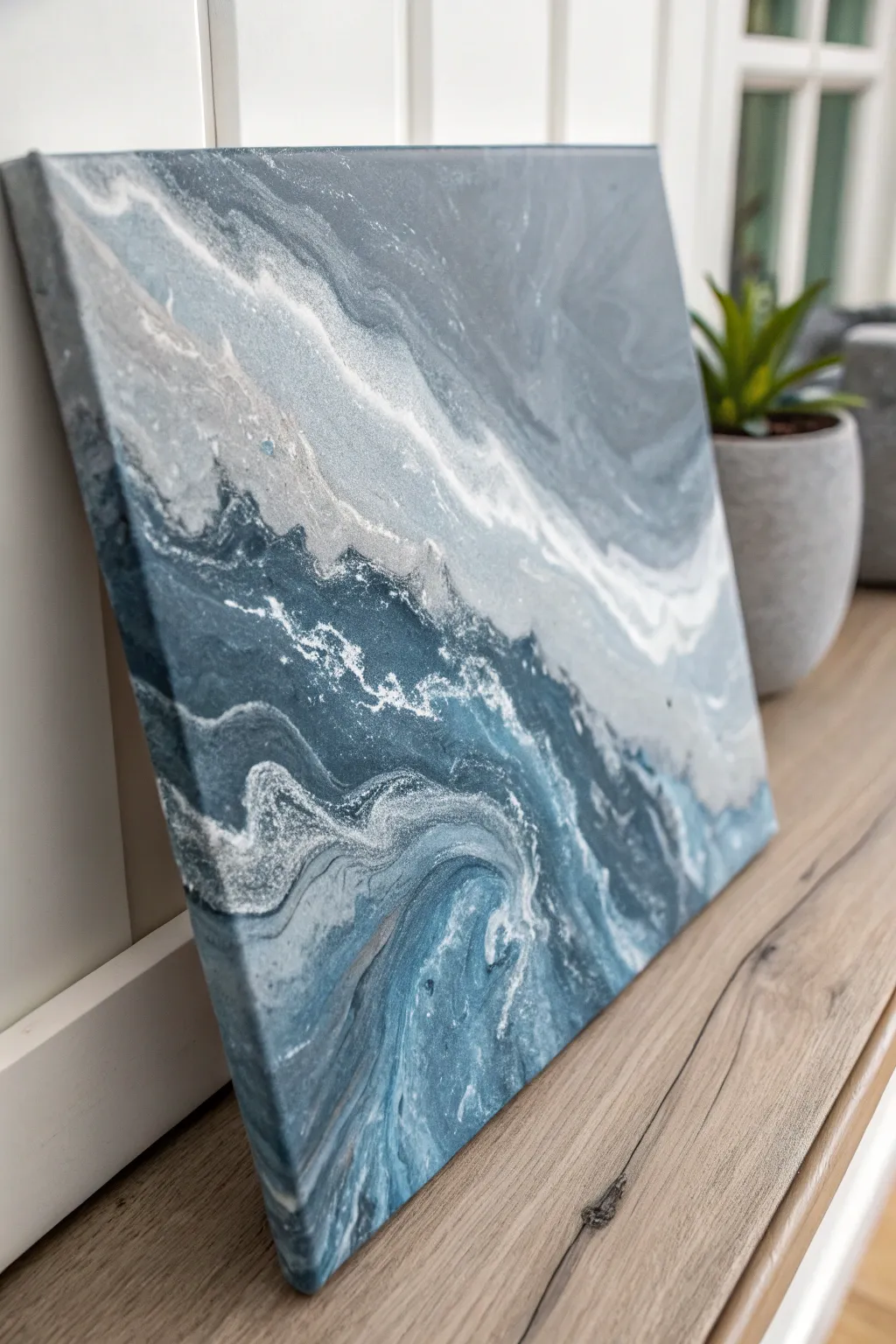 Stormy gray and steel blue pour with shimmering silver highlights in a calm minimalist mood.