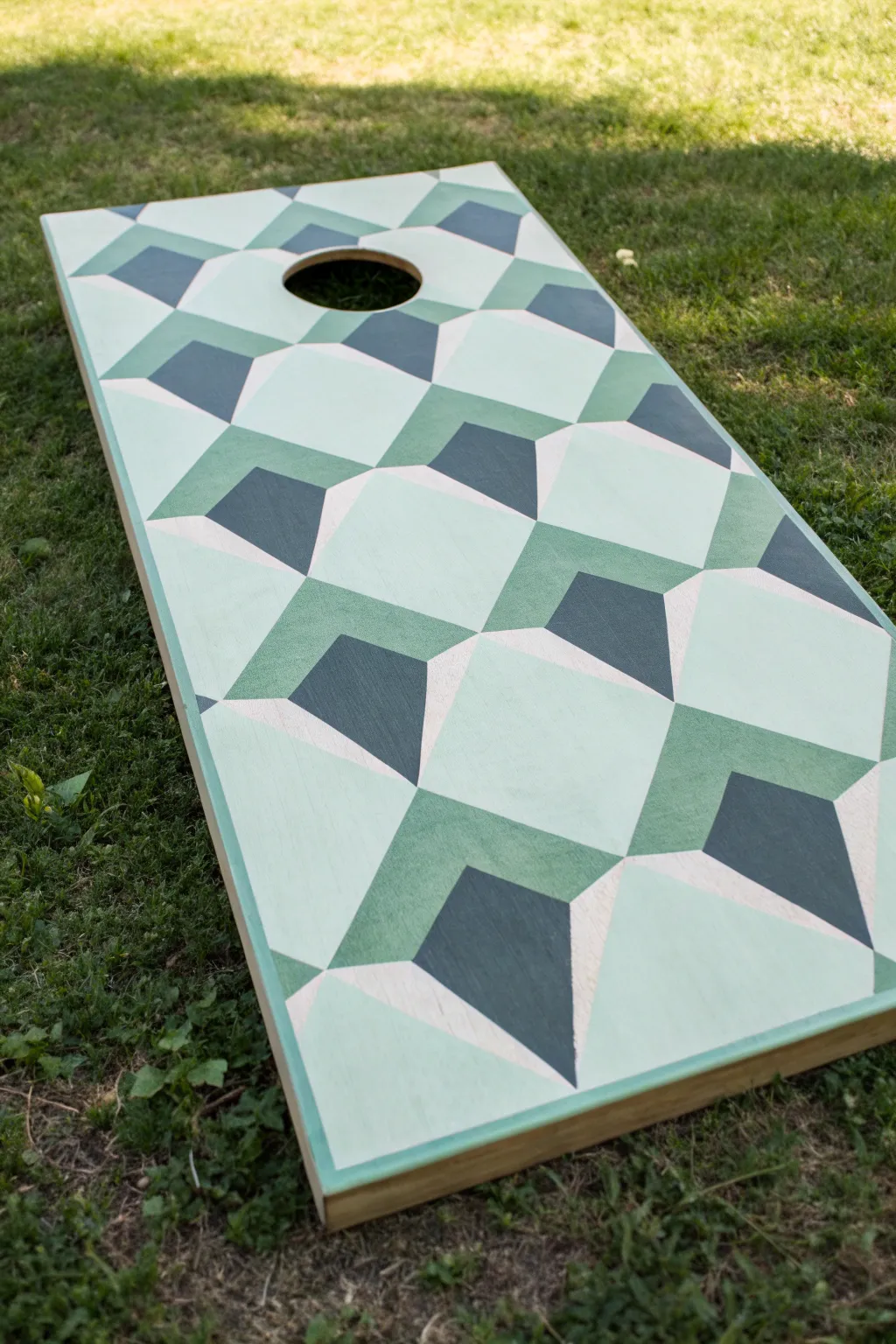 Sage 3D cube illusion paint pattern that frames the hole with crisp, modern contrast