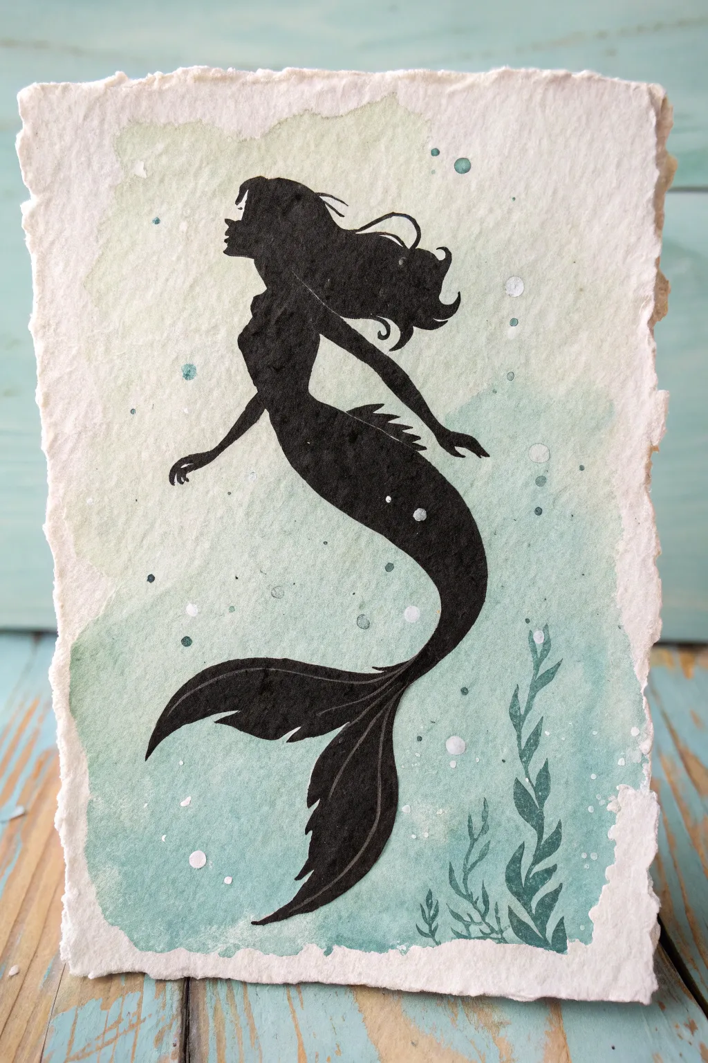 Minimal mermaid silhouette with flowing hair, bubbles, and soft rays for easy underwater art.