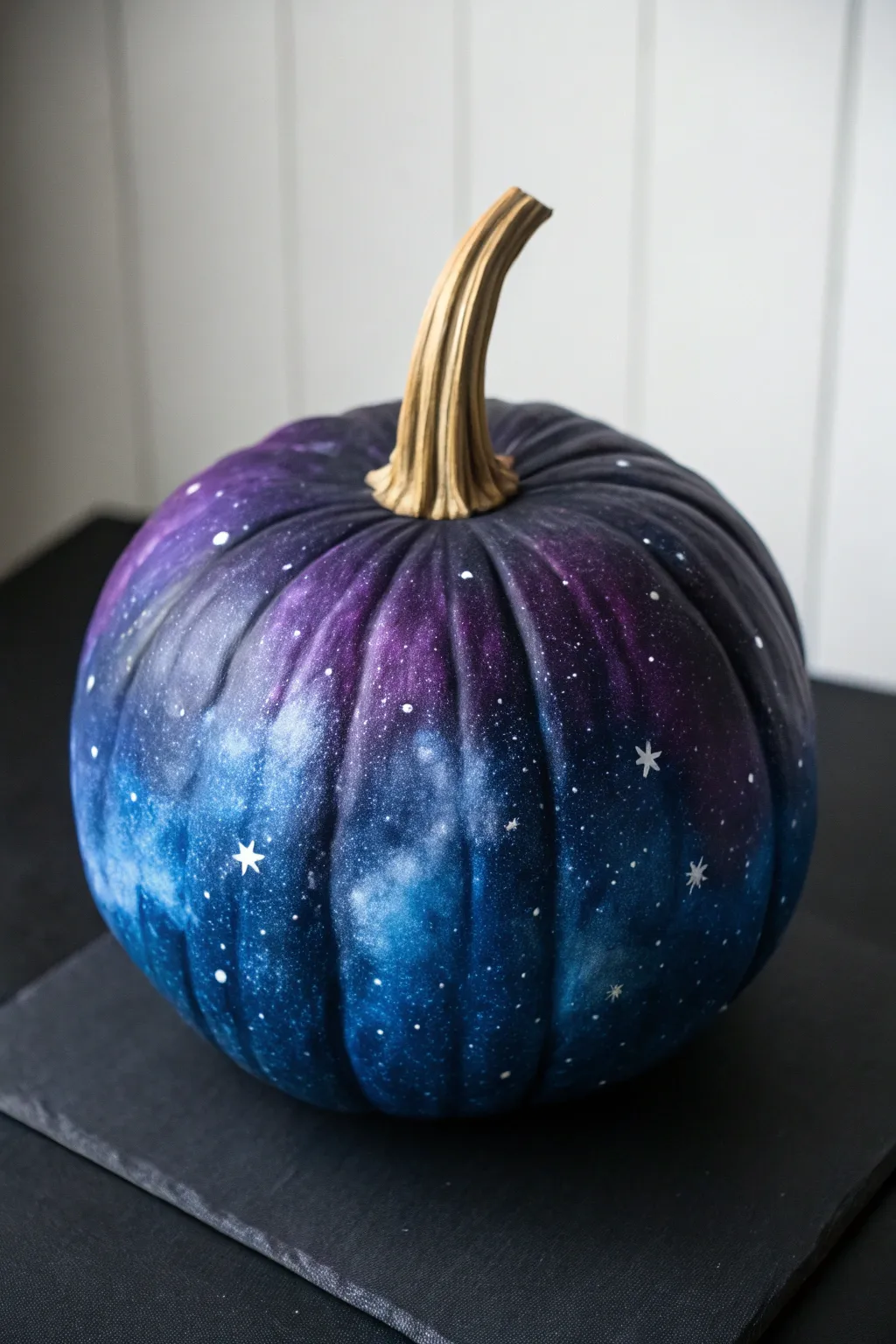 DIY galaxy pumpkin in deep blues with star splatter, minimalist and striking for autumn nights