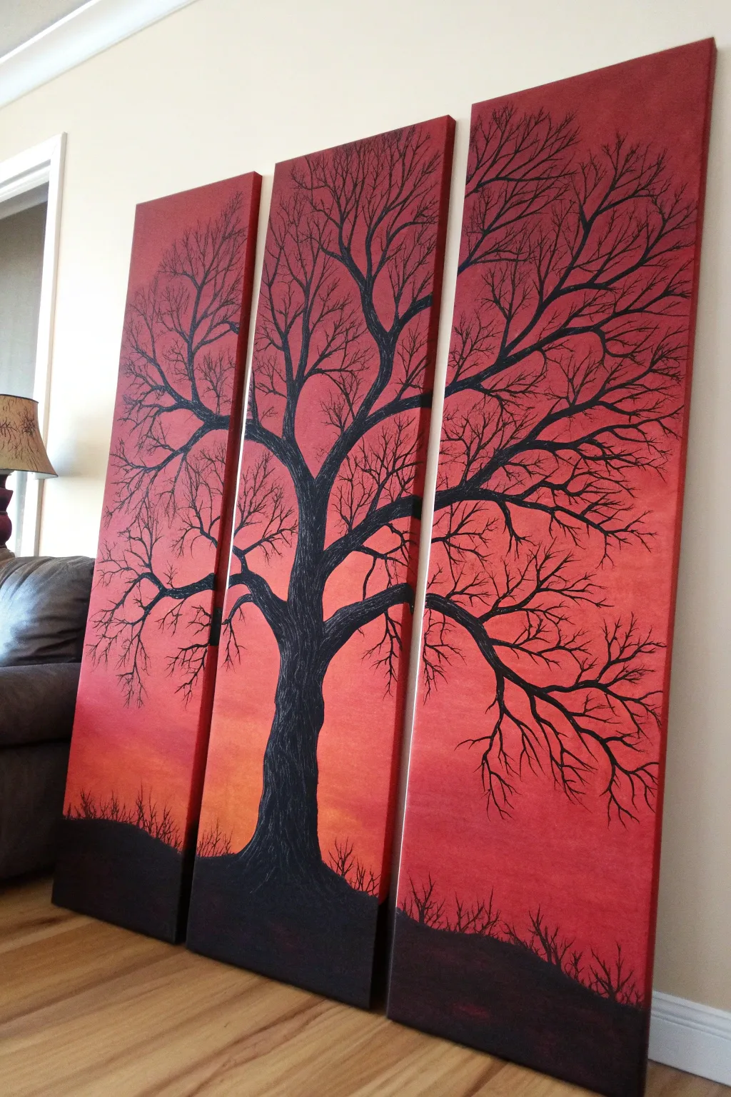 Bold red triptych tree silhouette, minimalist panels with rich tonal contrast and craft texture