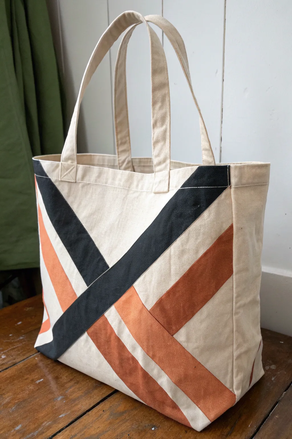 Bold diagonal tape-resist angles on a tote, crisp edges revealed for minimalist boho contrast