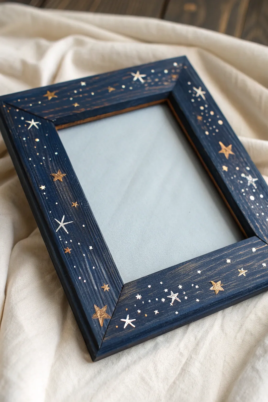 Starry night hand-painted wooden frame on black linen with subtle splatter and craft tools