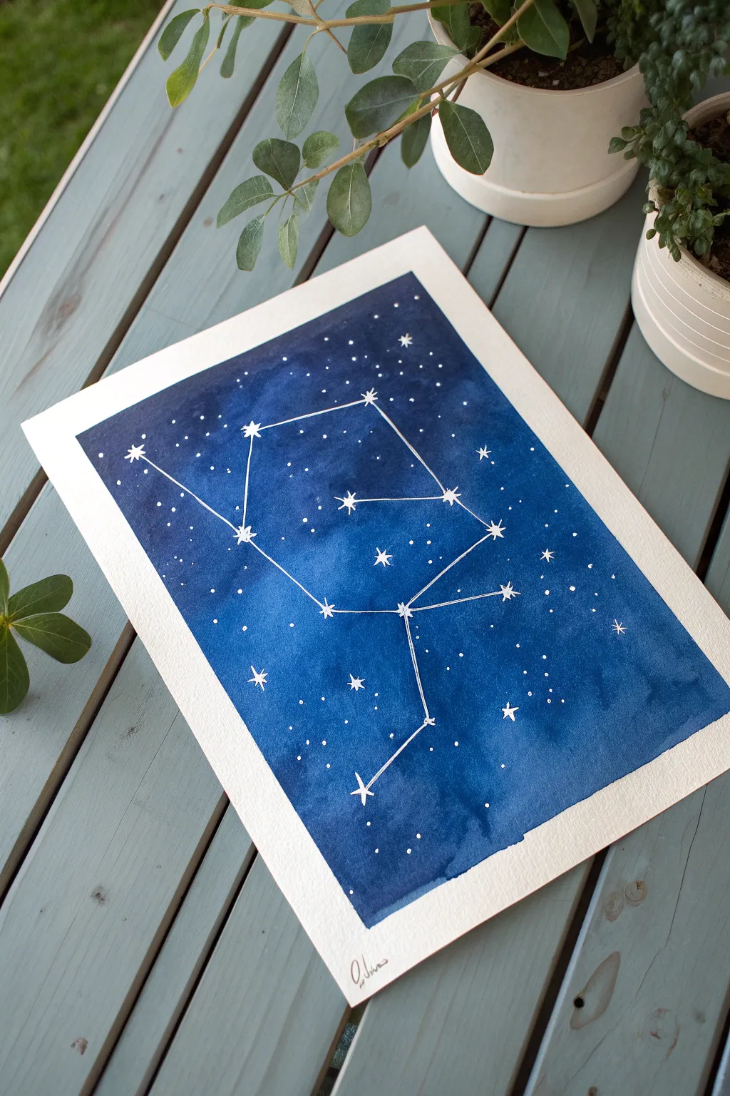 DIY tape-resist constellations on a deep blue canvas, crisp white stars and dreamy splatter glow