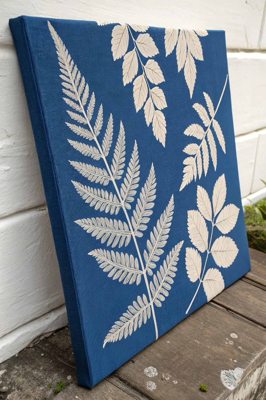 Bold cobalt canvas with crisp stenciled leaf imprints for a modern boho minimalist statement