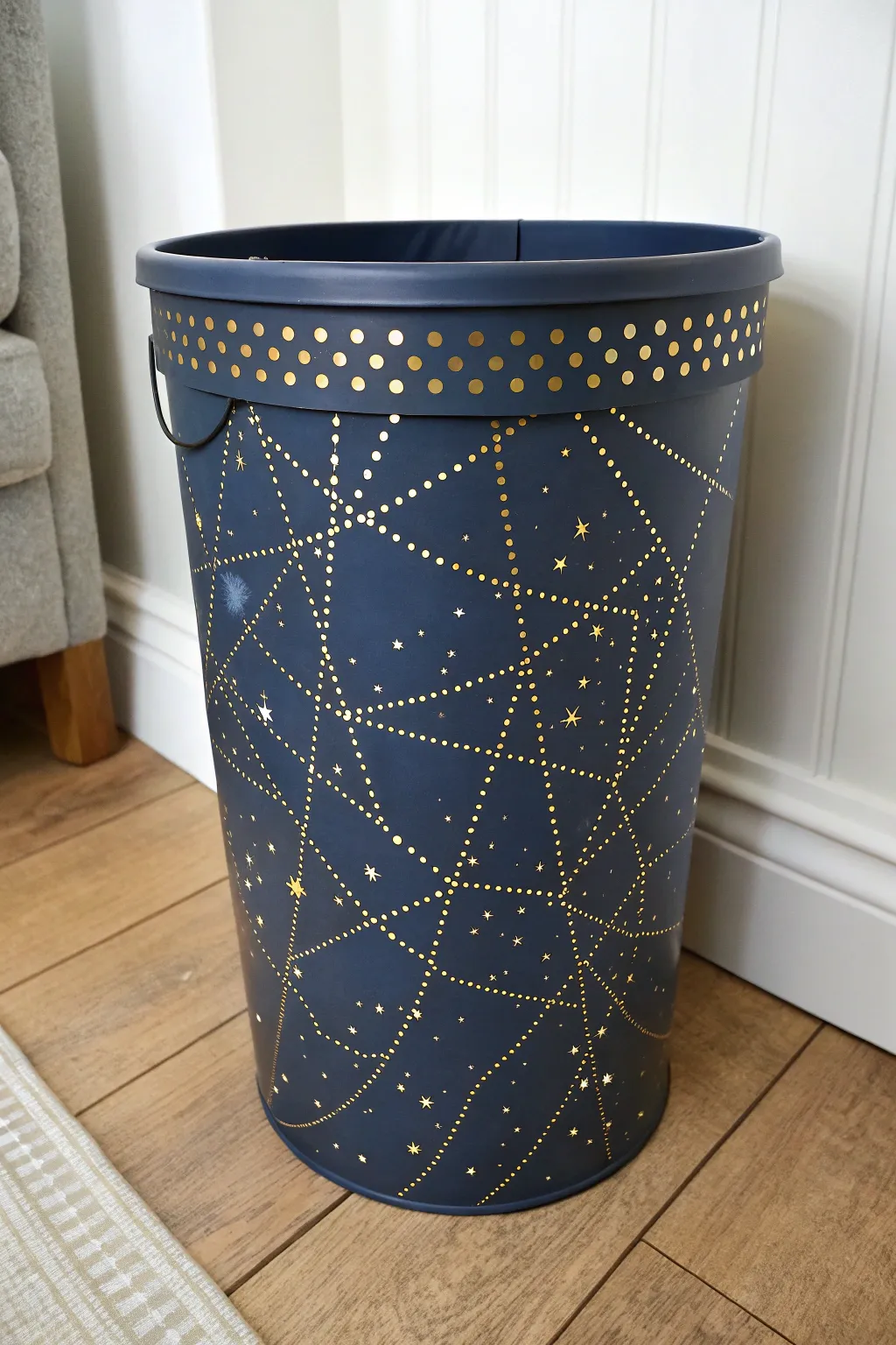 Glow constellation trash can in a dim hallway, minimalist and magical with bold starry contrast