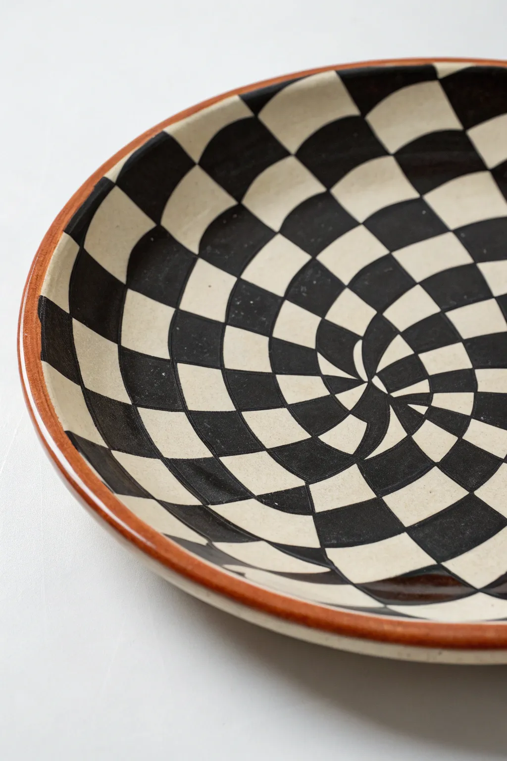 Warped checker plate painting idea with a bold optical illusion that curves with the dish