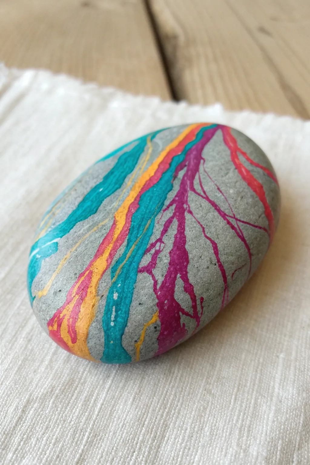 Transform ordinary stones into vibrant abstract art with this satisfying melted crayon technique.